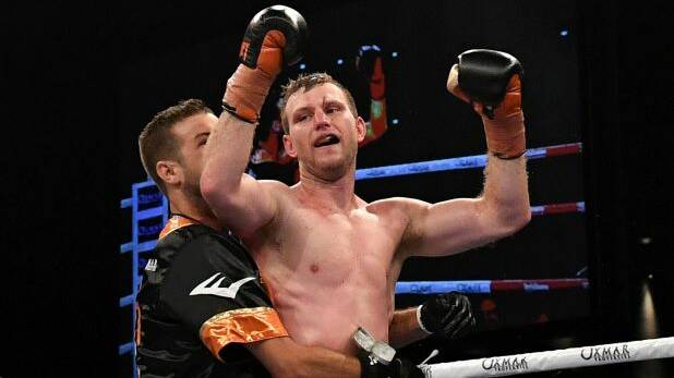 Hornet stings: Jeff Horn celebrates after successfully defending his WBO world welterweight champion title against UK boxer Gary Corcoran. Photo: AAP