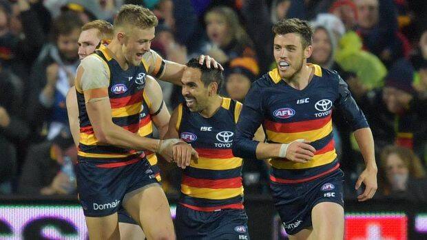Livewire: Eddie Betts is congratulated after scoring one of his three majors. Photo: AAP
