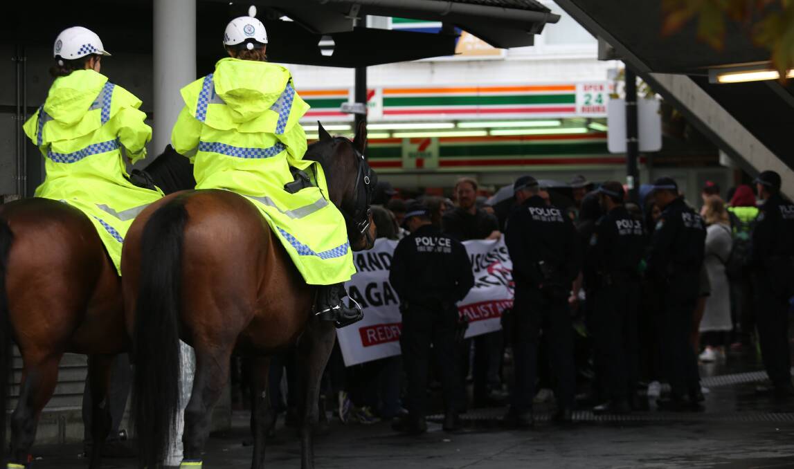 Barricade: Mounted police and OSG officers acting as a barrier between the two protest groups. Picture: Kevin Nguyen