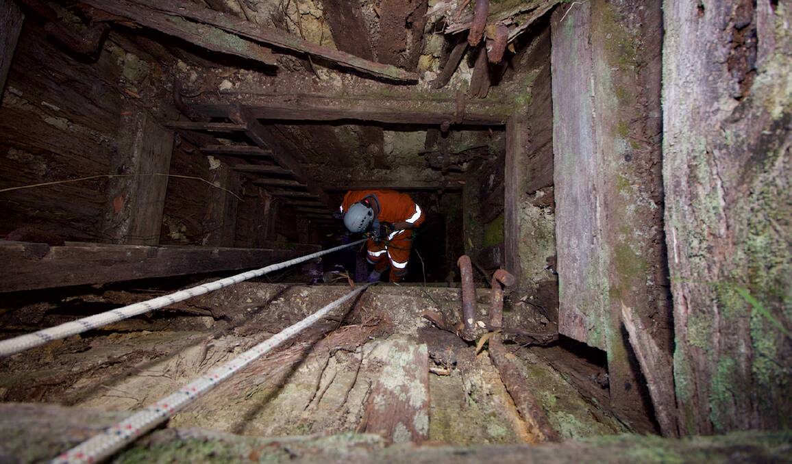 Down under: A member of The Victorian Historical Mine Shaft Chasers abseils down a shaft. Picture: Dean Anthony. 