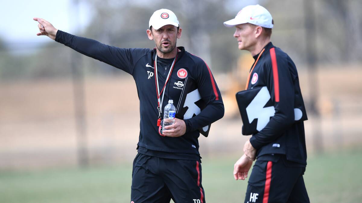 Tony Popovic points his way to the door, taking on a job with Turkish club Karabukspor, but leaving Hayden Foxe as interim coach. Picture: AAP Image/David Moir