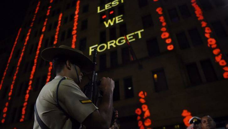 Anzac Day dawn service: Words are projected onto a building in Martin Place. Photo: Nick Moir