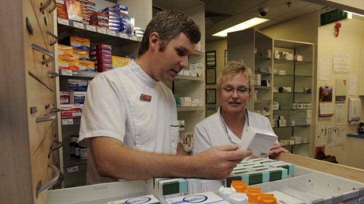Front line: Erindale Pharmacy has won a Defence Reserves
Support Council Award for the help manager, Beth Berry gives pharmacist reservist Luke  Peacock. Photo: Graham Tidy