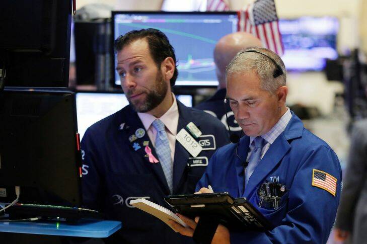 Specialist Michael Pistillo, left, and trader Timothy Nick work on the floor of the New York Stock Exchange, Thursday, Oct. 19, 2017. Technology companies and banks are leading U.S. stocks slightly lower in early trading on Wall Street. (AP Photo/Richard Drew)