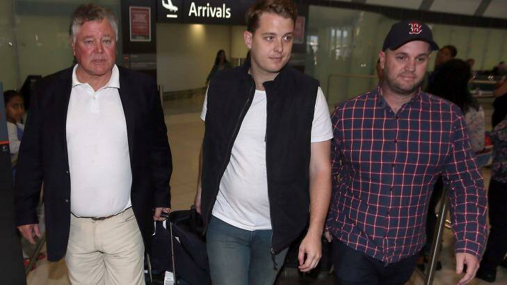 Jack Walker, centre, and his father John Walker, left, arrive at Perth international airport on Friday afternoon. Photo: Diimex