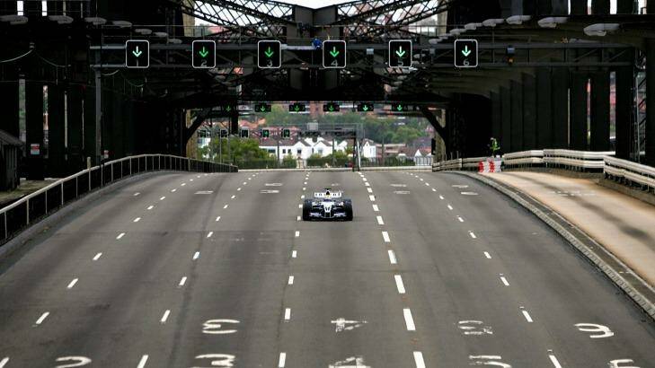 Mark Webber drives his car across the Sydney Harbour Bridge in a promotional event in 2005.  Photo: David Gray