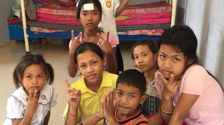 Children pose for photographs at a Phnom Penh orphanage in Decermber.
 Photo: Lindsay Murdoch