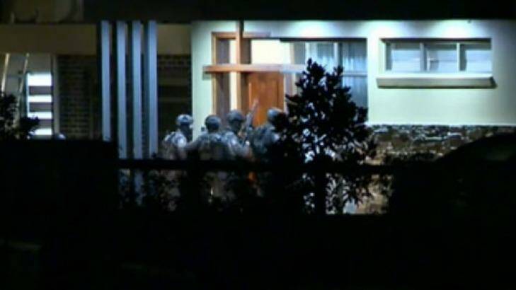 Tactical Operations Unit officers enter a home in Luddenham about midnight. Photo: Nine News