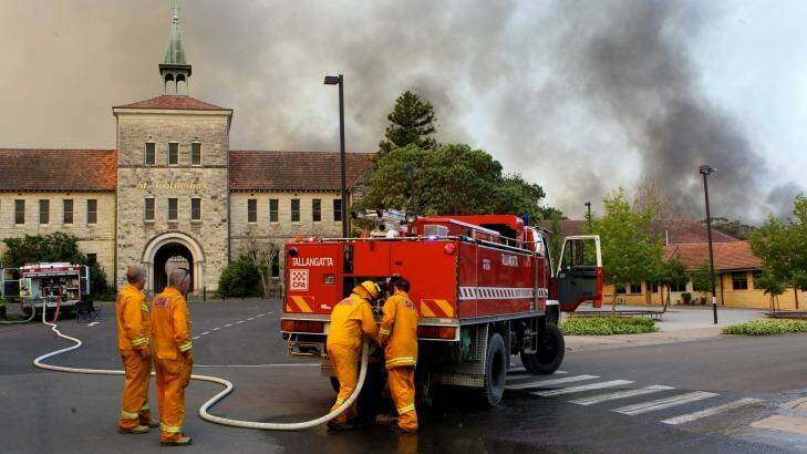 Firefighters tackle a bushfire in Winmalee near St Columba's School in October 2013. Photo: Janie Barrett