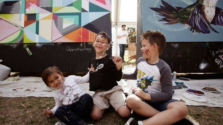 Pint-sized painters: Ruby Rehu, 3, Kaelan Russell, 6, and Isaiah Marinos, 6, at a Darling Harbour outdoor exhibition space. Photo: Fiona Morris
