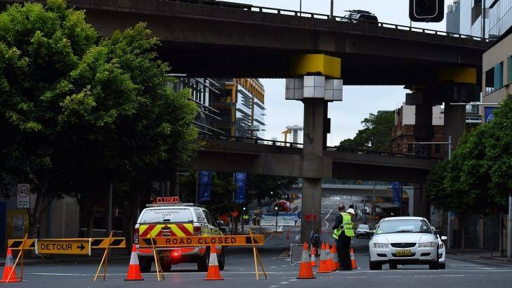 Police closed Sussex and Hickson streets as experts worked to find a way to lower the damaged crane at Barangaroo. Photo: Kate Geraghty