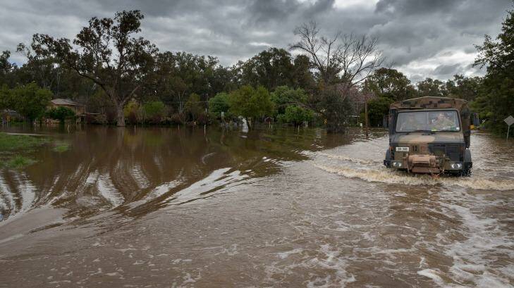 An Australian Army Unimog truck from 5th Brigade moves through inundated roads during flood relief operations in Forbes. Photo: Kyle Genner