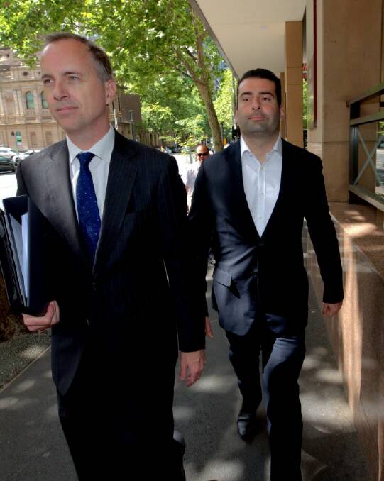 Former NAB banker Andrew Matthews (right) on charges he defrauded customers of $855,000 by falsifying bank loans.seen here leaving the Melbourne Magistrates Court with his lawyer. 21st November 2017. Photo by Jason South