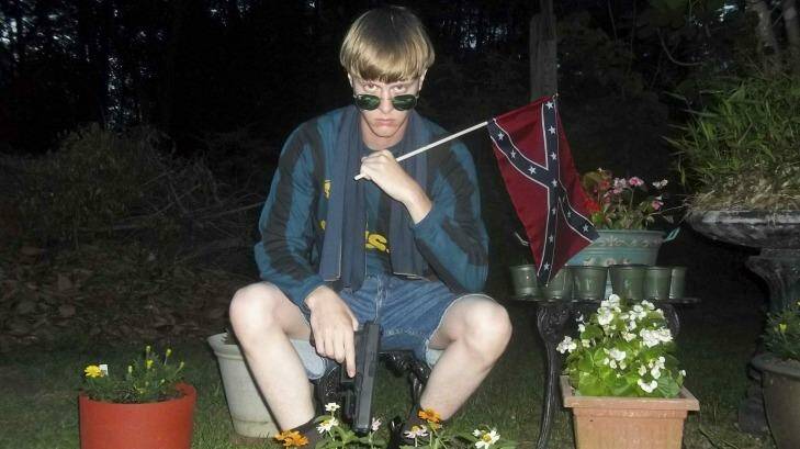 Dylann Roof, charged with carrying out the Charleston church massacre, poses with a Confederate flag and a Glock pistol in  this photo with a digital timestamp of April 27, 2015.  Photo: Supplied