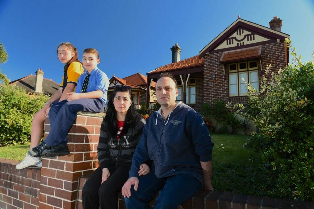 "You're in limbo": Joe Cavallaro with his wife, Vera, and children Alfio and Marchella, outside the Haberfield home they recently sold to the government.  Photo: Steven Siewert