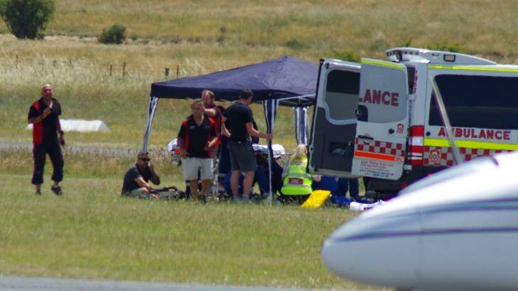 A 14-year-old boy is treated after a skydiving accident at Goulburn airport on Saturday. Photo: Darryl Fernance