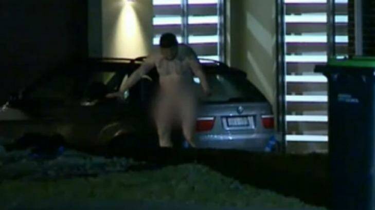 A naked man emerges from the home in Luddenham after a home invasion. Photo: Nine News