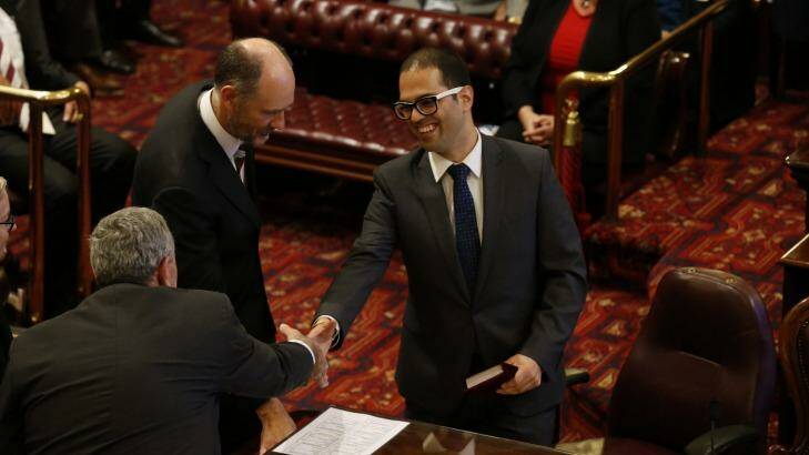 Newly appointed Upper House MP Daniel Mookhey shakes hands with Liberal MP Duncan Gay. 