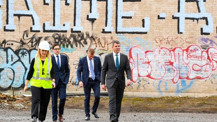 NSW Premier Mike Baird (right) arrives at the goods yard in Rozelle on Thursday to announce the extension. Photo: Peter Rae