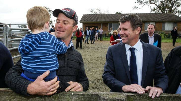 Mike Baird talks to  Woodville dairy farmers David Vollmer and his son Thomas. Photo: Ryan Osland