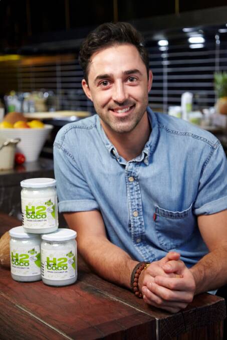 H2COCO ambassador: Andy Allen with bottles of H2Coco organic virgin coconut oil, sold at Chemist Warehouses nationally. Picture: Kate Tarala