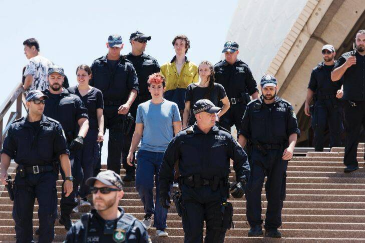 At 10:30 am activists tried to unfurl a protest banner over the west-facing sail of the Sydney Opera House with personal banners calling to #EvacuateManus. Pictured are the two protestors arrested. Thursday 9th November 2017. Photograph by James Brickwood. SMH NEWS 171109