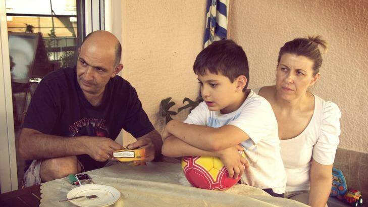 Minos Prinarakis, his wife Natassa Limou and their son Manos at home in Larissa, Greece, in 2015. They've been dealing with Greece's financial crisis for four years. Photo: Nickos Ventouras