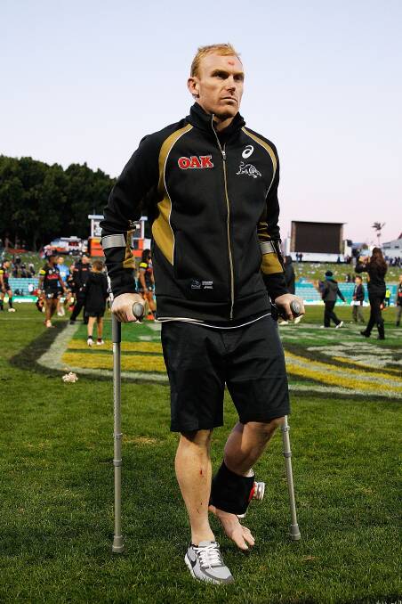 SYDNEY, AUSTRALIA - JULY 06: Peter Wallace of the Panthers leaves the field on crutches following the round 17 NRL match between the Wests Tigers and the Penrith Panthers at Leichhardt Oval on July 6, 2014 in Sydney, Australia.  (Photo by Brendon Thorne/Getty Images)