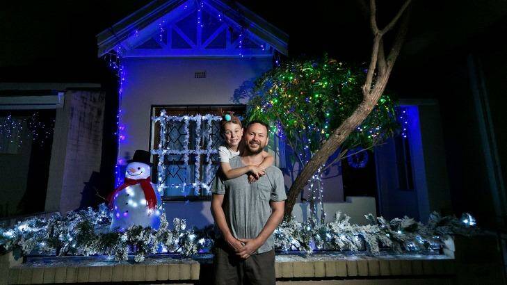 SYDNEY, AUSTRALIA - DECEMBER 10: <Jason Bell with 7 year old Zy with their winning entry in this year's street party lights competition. Christmas lights display at Pleasant St, Erskinville> on December 10, 2016 in Sydney, Australia. (Photo by Sarah Keayes/Fairfax Media) Photo: Sarah Keayes