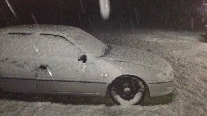 Snow covers a car parked at Hartley in the Blue Mountains. Photo: Kyle Johnson