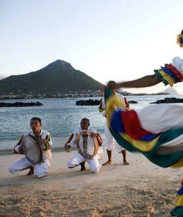 Swirling colours: A woman performs the sega, the national dance of Mauritius.
