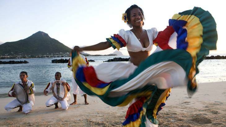 Swirling colours: A woman performs the sega, the national dance of Mauritius.
