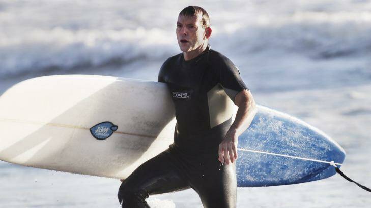 Tony Abbott, pictured surfing in 2014, went to hospital for a "couple of stitches" after encountering rough surf conditions on Friday morning. Photo: Nick Moir