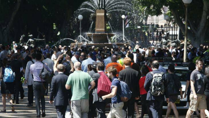People are evacuated to Hyde Park during a siege in Martin Place.  Photo: Peter Rae