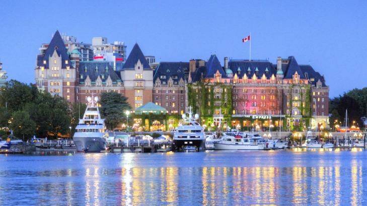 The lights of the grand architecture along the Inner Harbour are reflected in the water. 
