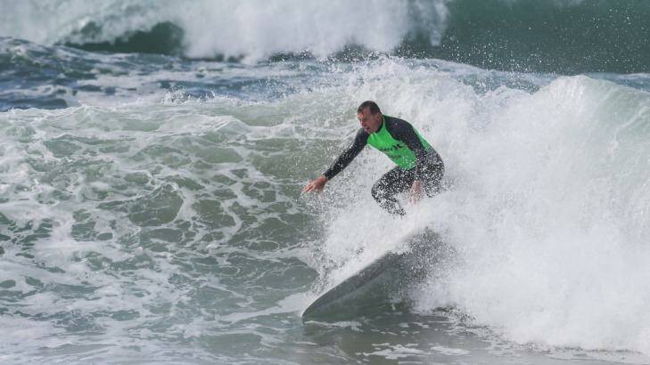 Mr Abbott pictured during a surf competition last year.  Photo: Dallas Kilponen