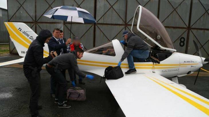 Police unload bags from the plane at Deniliquin airport. Photo: NSW Police