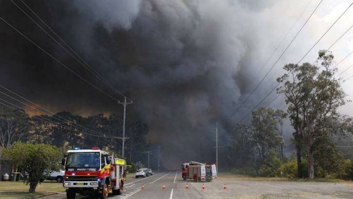 Smoke looms over the Newcastle suburb of Kurri Kurri. Photo: Michael John Fisher