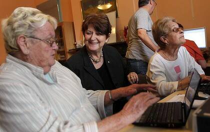 Susan Ryan ( centre) watches Dawn Endycott and Elaine Grant learn to use computers at a Seniors internet Cafe.