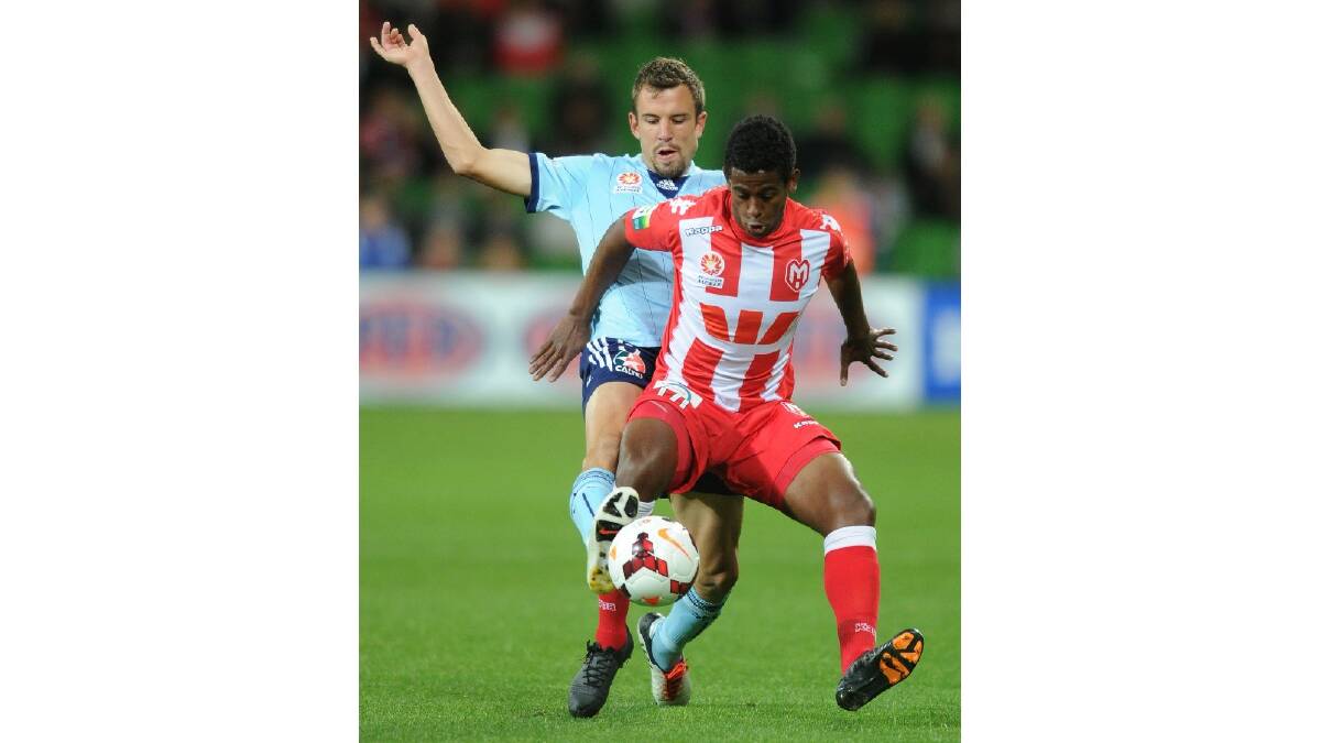 Golgol Mebrahtu of the Heart is tackled by Matthew Jurman of Sydney during the round six A-League match between the Melbourne Heart and Sydney FC. Photo: Getty Images.